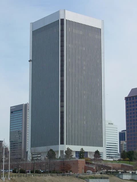 Exterior view of the tall, white and black striped building of the Federal Reserve Bank in Richmond, Virginia.