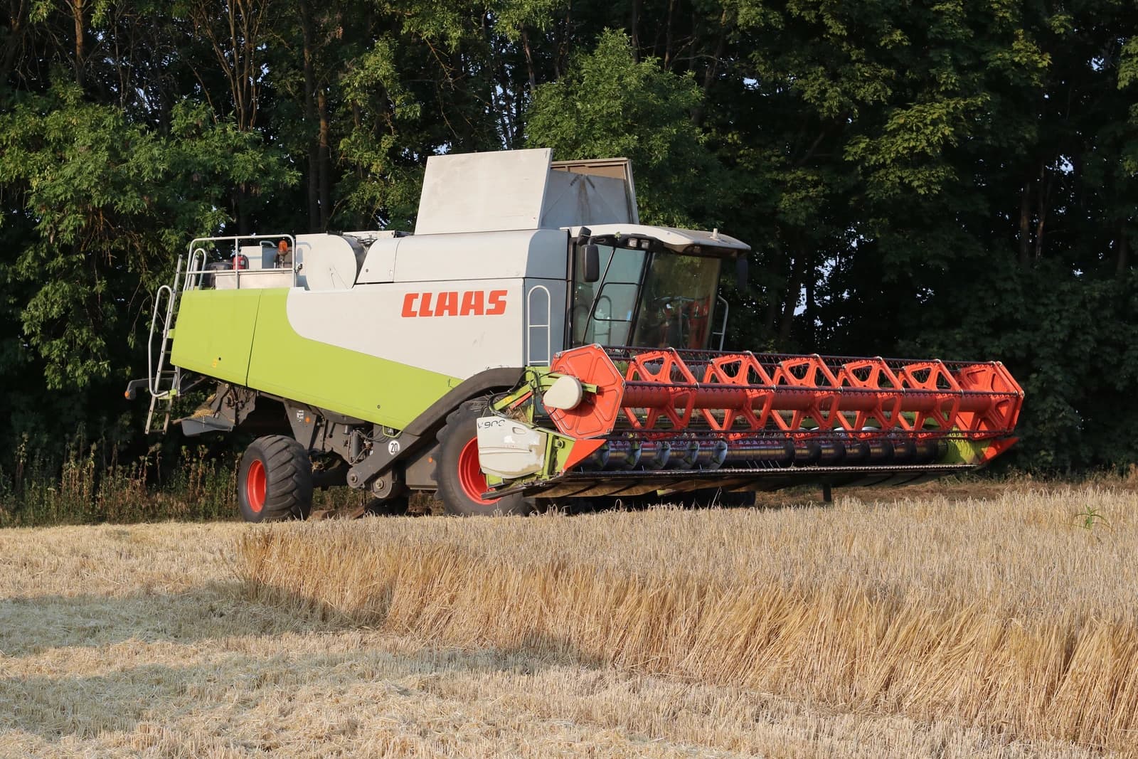 Claas Lexion 580 combine harvester in a field of golden wheat.