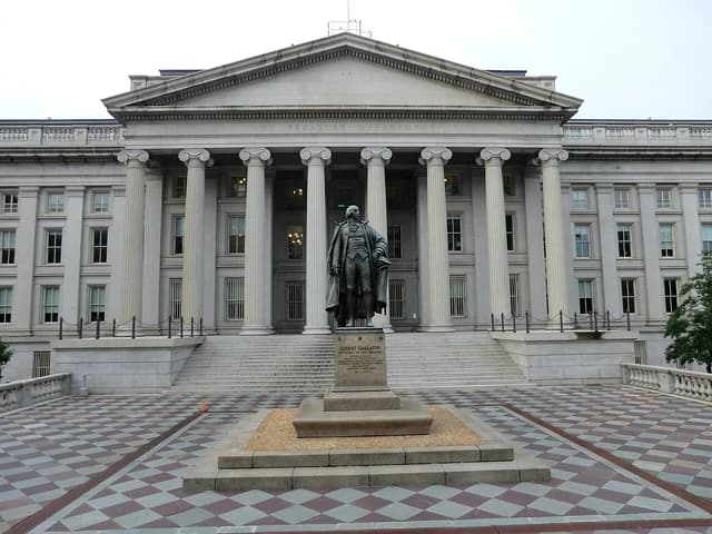 A statue of Albert Gallatin stands in front of the U.S. Treasury Department headquarters building.