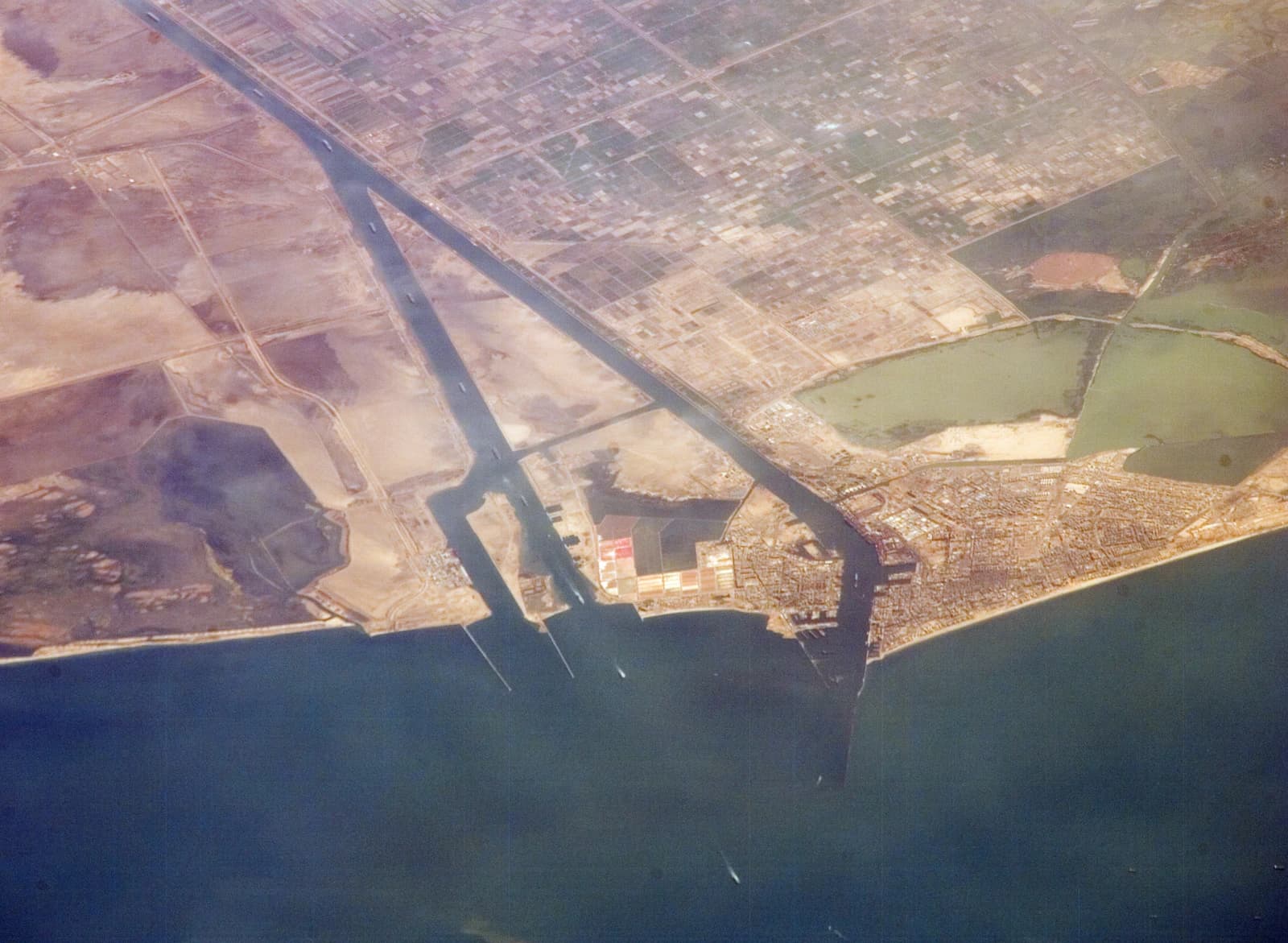 Aerial view showing the Suez Canal passing through Port Said, connecting to the Mediterranean Sea.