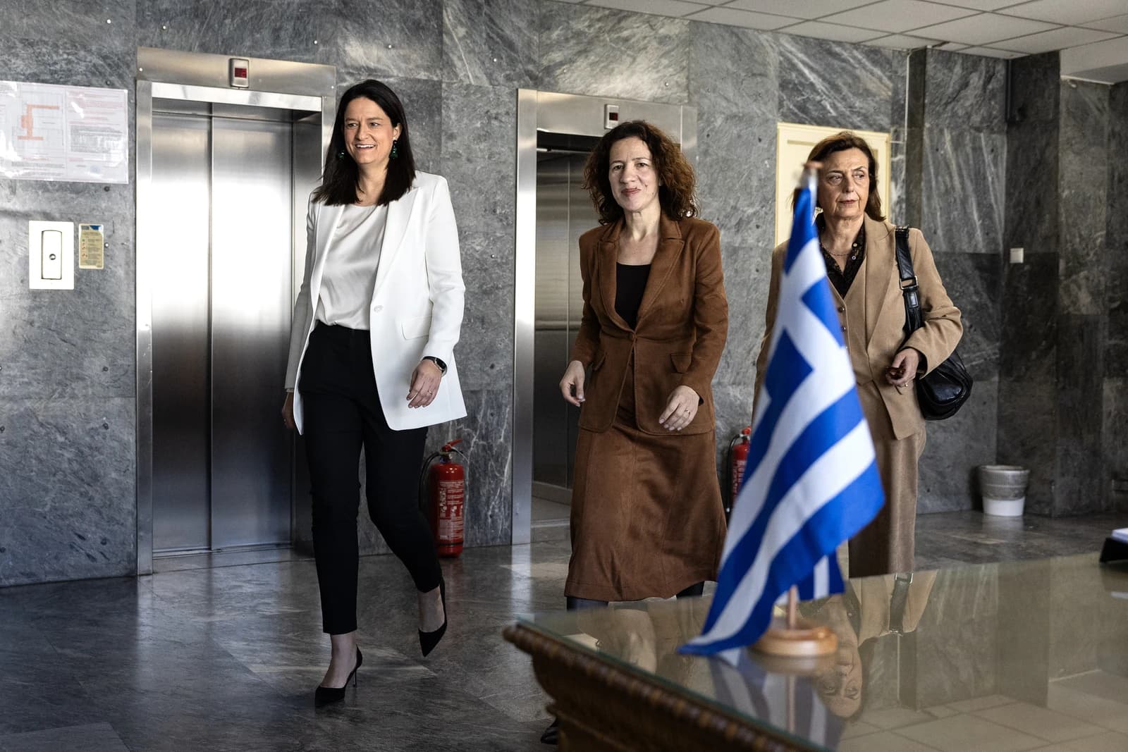 Roxana Mînzatu, Executive Vice-President of the European Commission, walks through a modern building.
