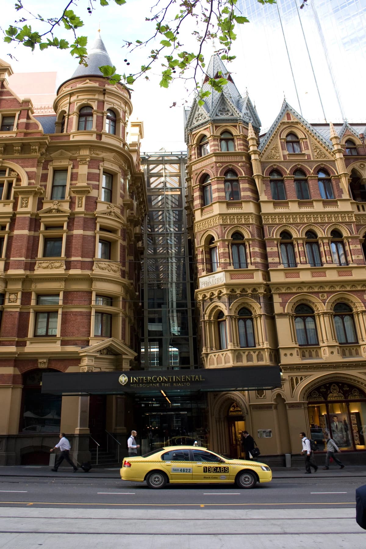 Rialto Building on Collins Street in Melbourne, Australia, with people and a taxi.
