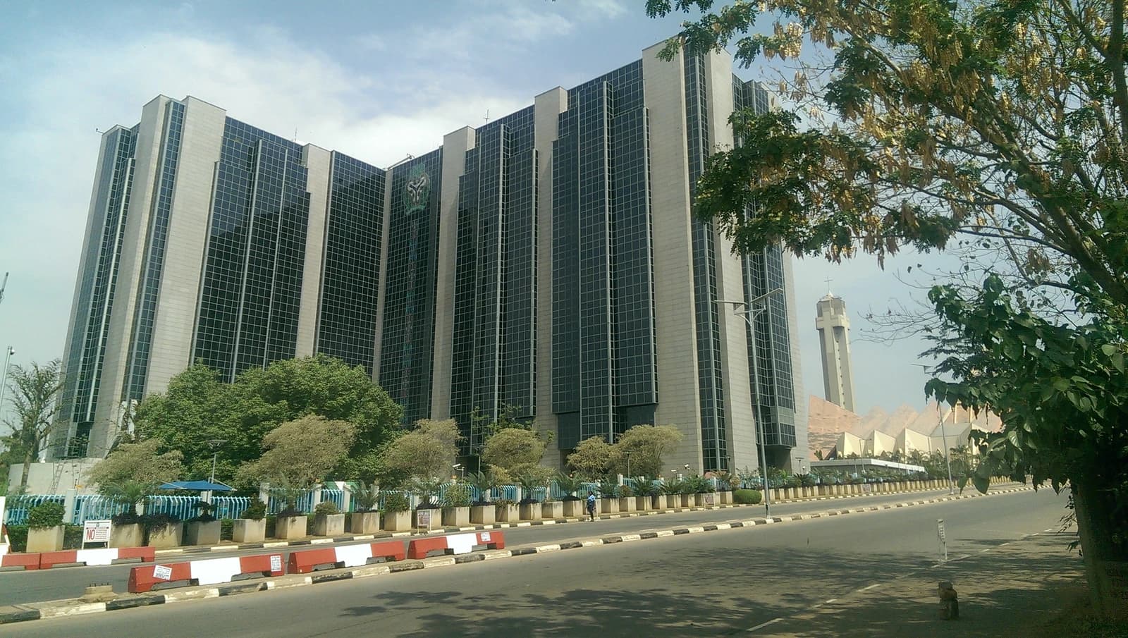 Central Bank of Nigeria building, a large modern skyscraper, in Abuja.