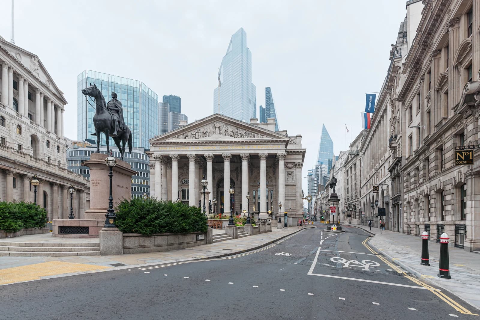 The Royal Exchange building stands at a quiet London intersection under a grey sky.