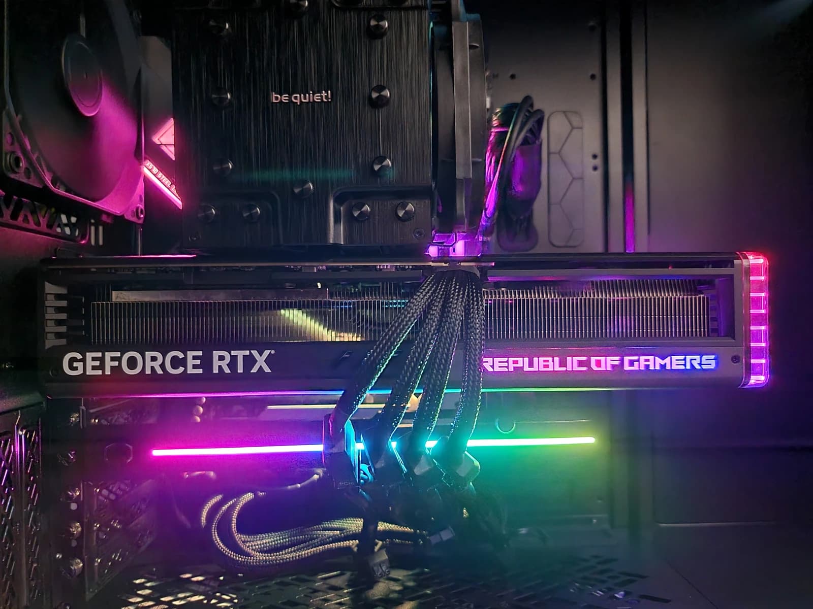 An illuminated Asus Strix RTX 4090 graphics card inside a computer case.