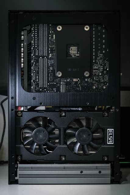 Internal view of a computer showing a graphics card with two fans and a motherboard.