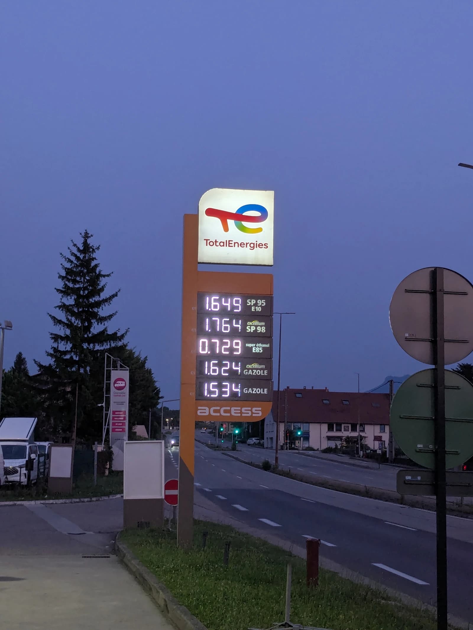 TotalEnergies gas station price sign in Voreppe, France, displaying current fuel prices.