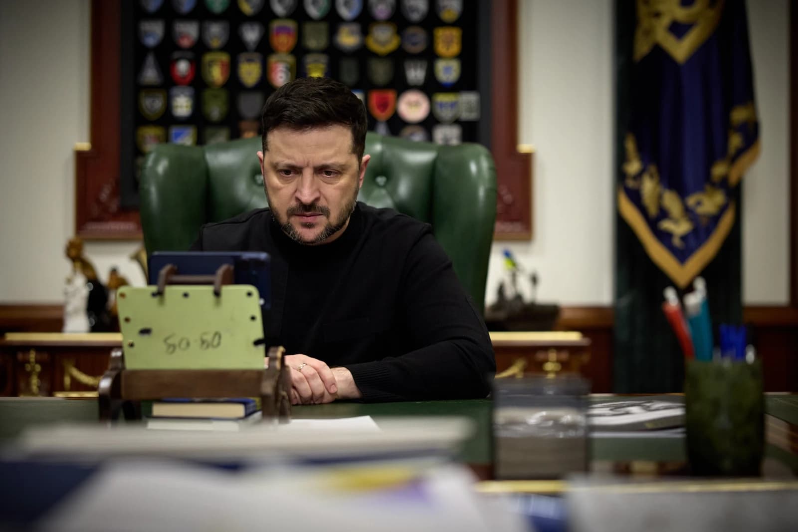 Volodymyr Zelenskyy, President of Ukraine, engaged in a video call or viewing content.