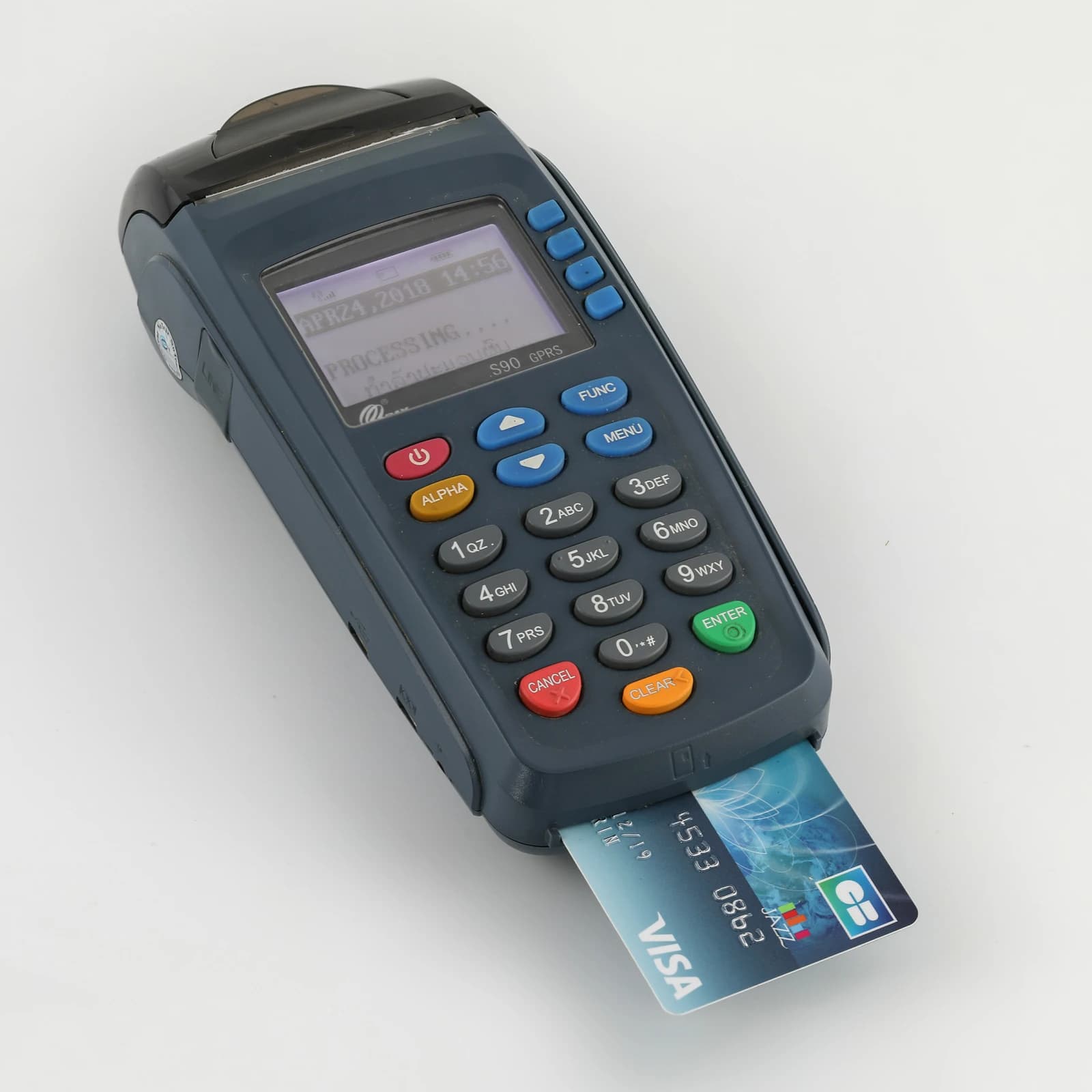 Credit card terminal showing 'Processing...' on screen with a Visa credit card inserted.