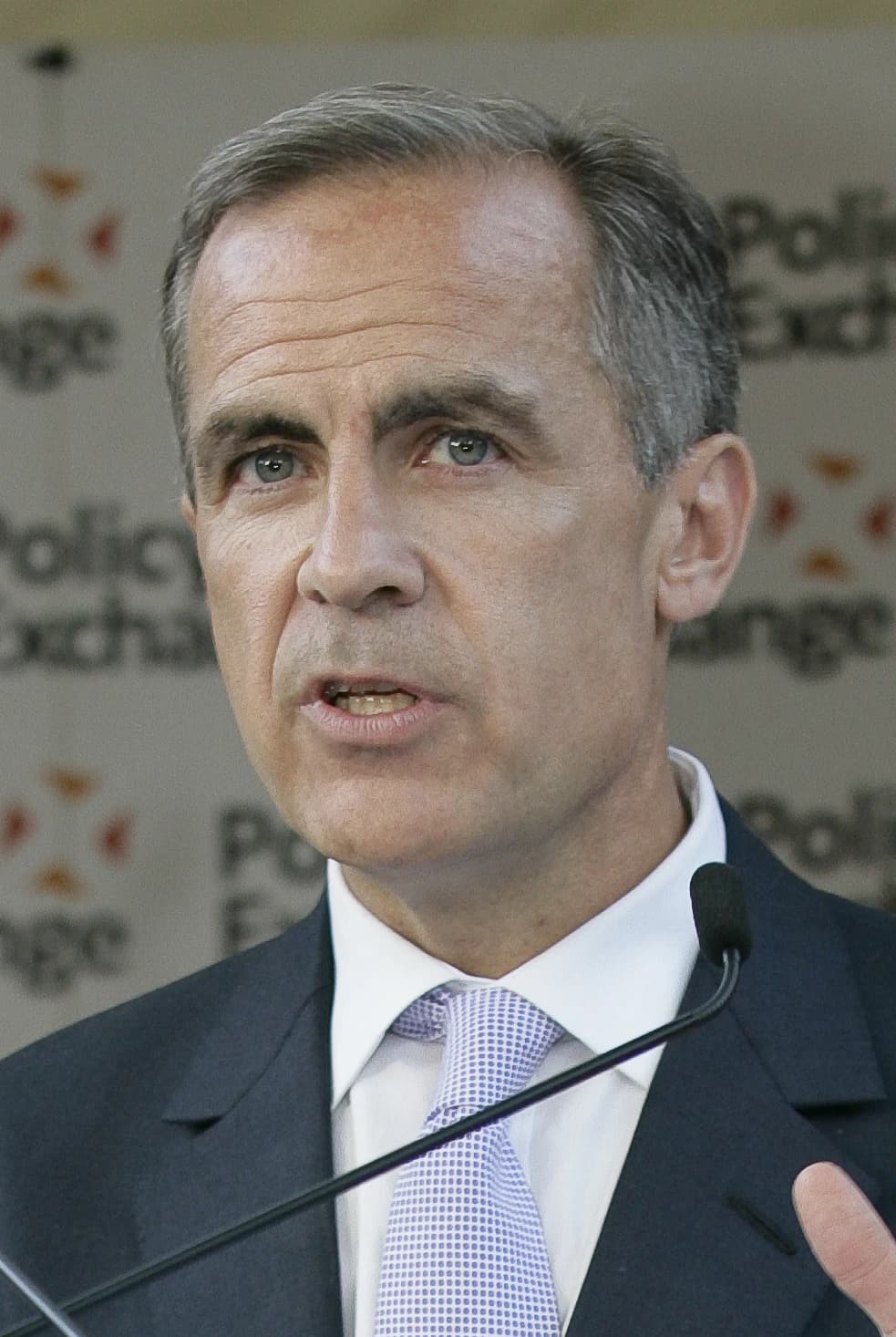 Mark Carney, Bank of England Governor, speaking at a podium with a microphone.