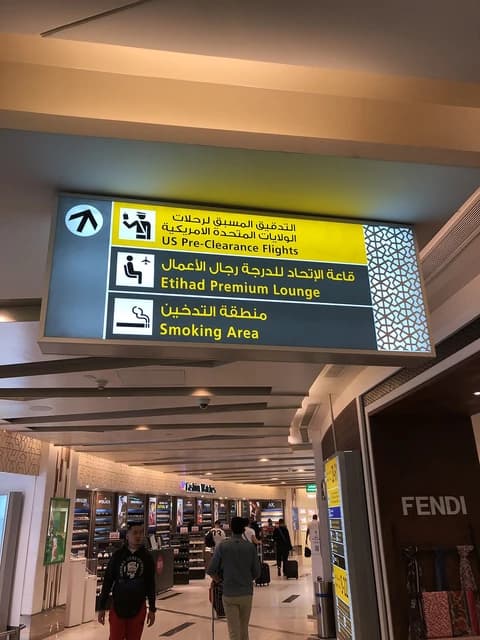 Sign at Abu Dhabi International Airport Terminal 3 for US Pre-Clearance Flights and Etihad Premium Lounge.