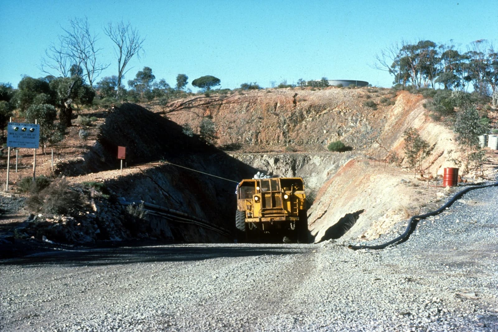 Large yellow ore truck entering a mine shaft at the Silver Swan Nickel Mine.