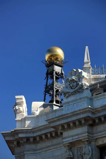 Close-up of the Bank of Spain building with a golden sphere and architectural details.