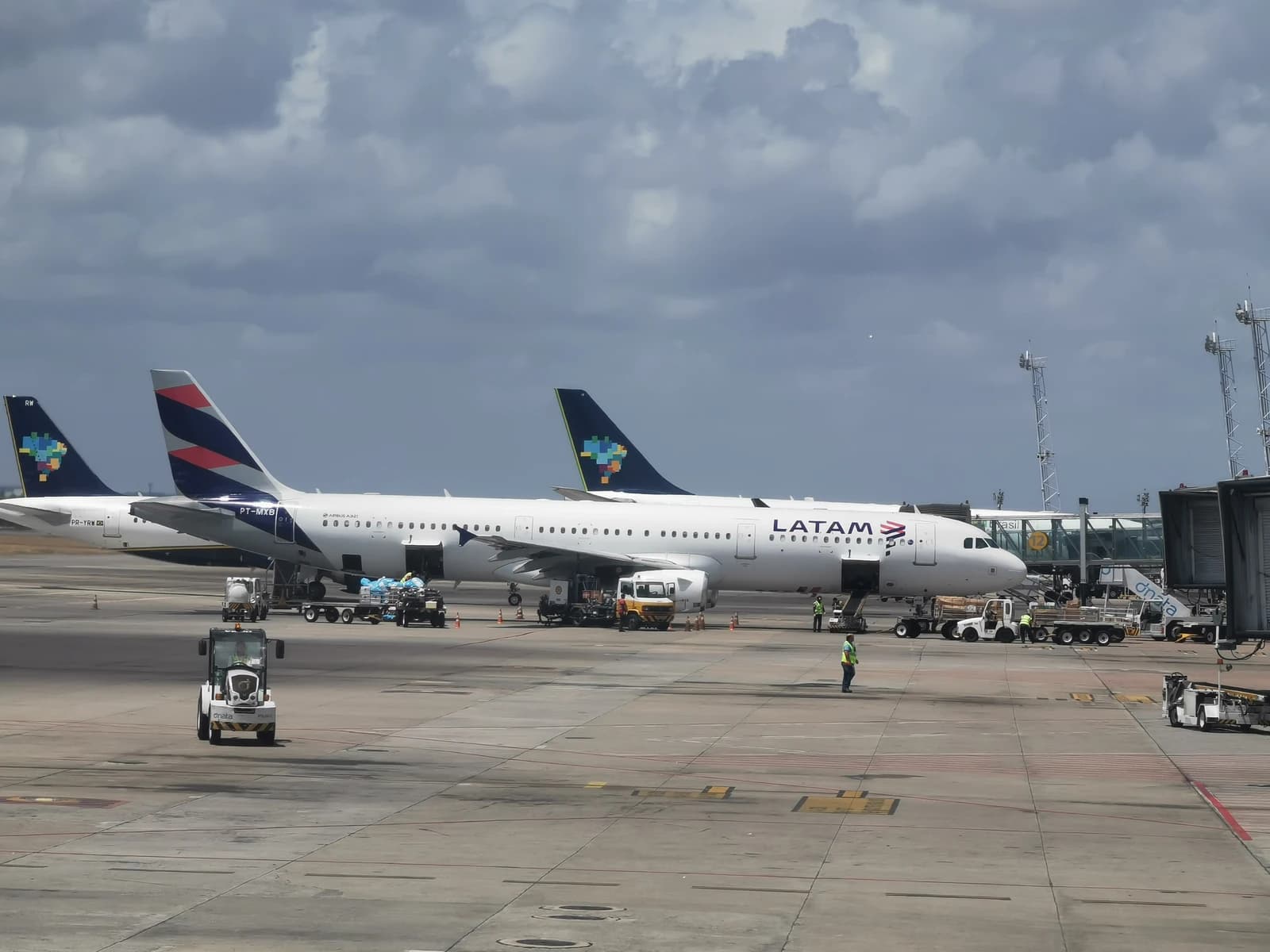 Two Airbus aircraft, one Azul and one TAM, parked at Salgado Filho Airport.