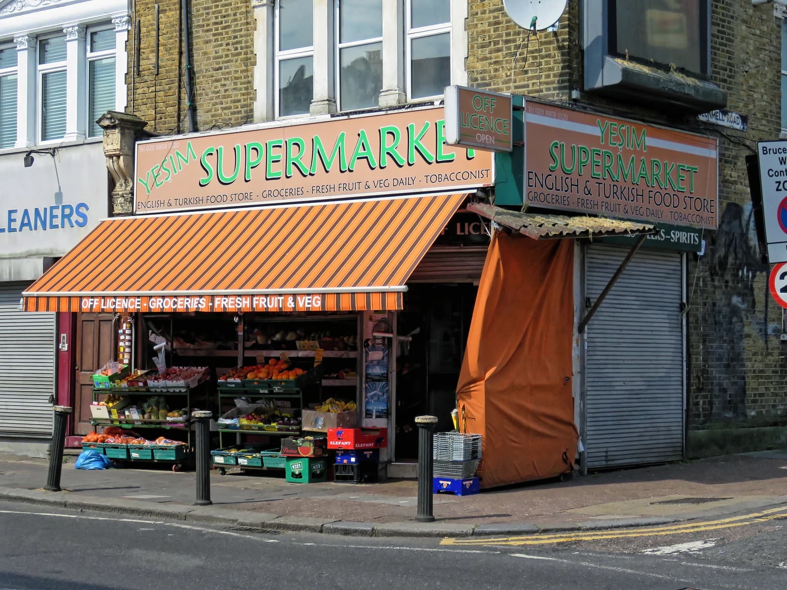 An open corner store, Yesim Supermarket, on a London street during the pandemic.