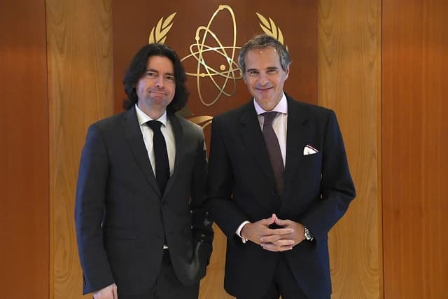 Guillaume Ollagnier and Rafael Grossi posing at the IAEA headquarters in Vienna.