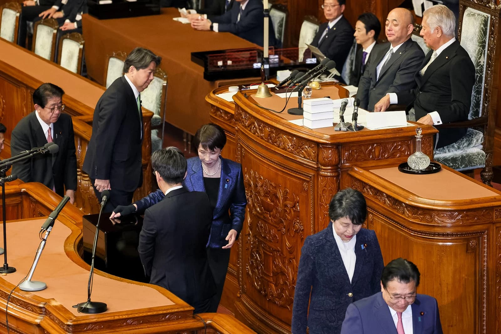 Sanae Takaichi, Prime Minister of Japan, standing in the House of Representatives during a session.