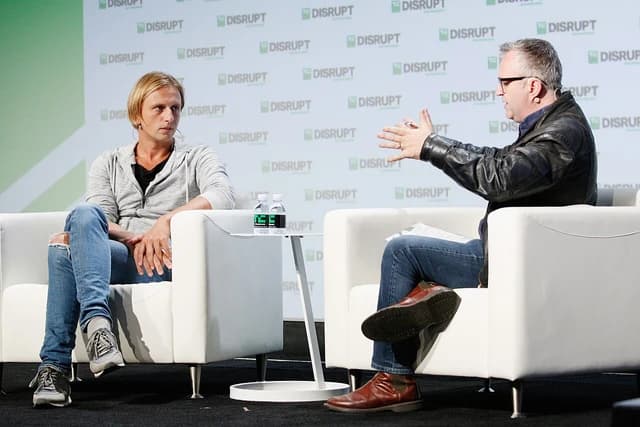 Nikolay Storonsky, co-founder and CEO of Revolut, sits on a white chair at an event.