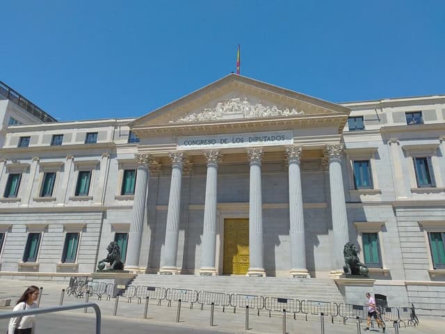 Exterior of the Congreso de los Diputados building in Madrid on a sunny day.