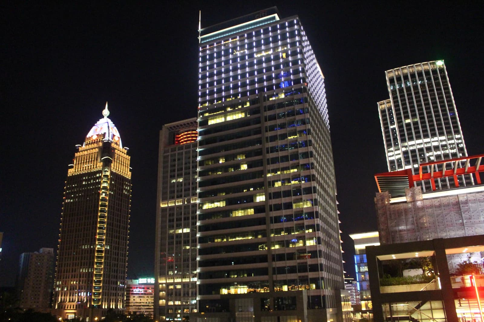 Skyscrapers lit up at night in Taipei's Xinyi financial district.