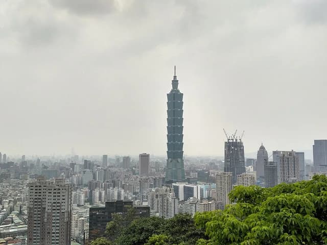Taipei 101 skyscraper standing tall amidst the dense urban landscape of Taipei.