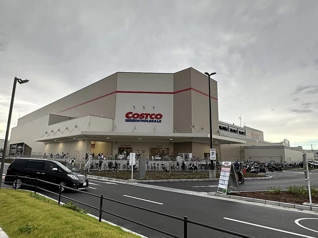 Exterior of Costco Kadoma warehouse store with customers entering and exiting.