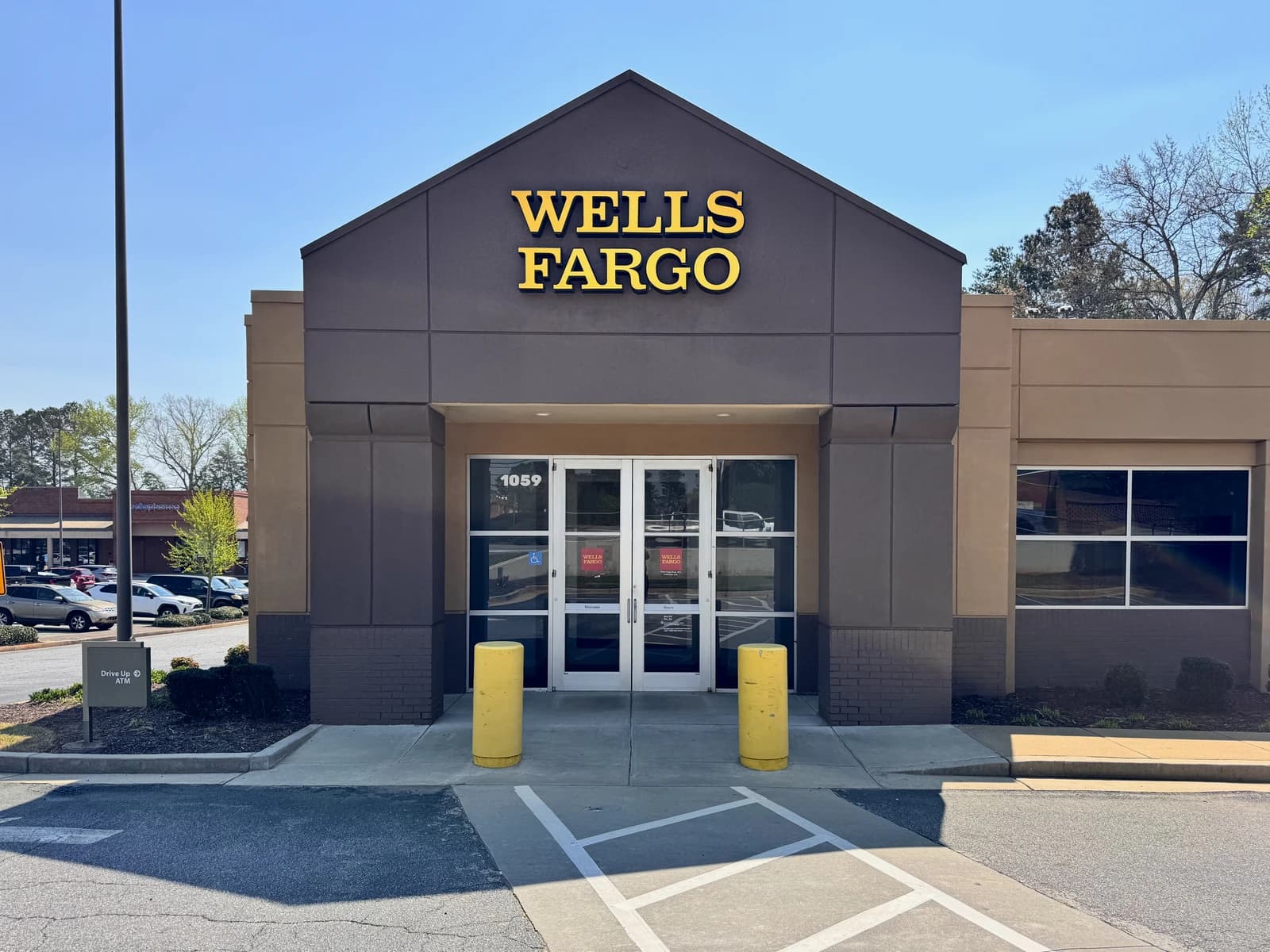 Exterior of a Wells Fargo bank branch in Athens, Georgia under a clear sky.