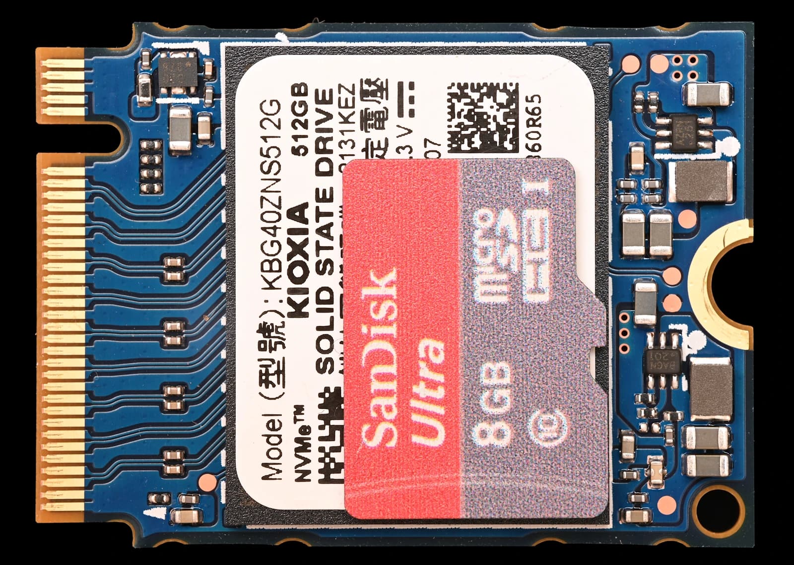 Kioxia M.2 2230 solid state drive compared to a SanDisk Micro-SD card.