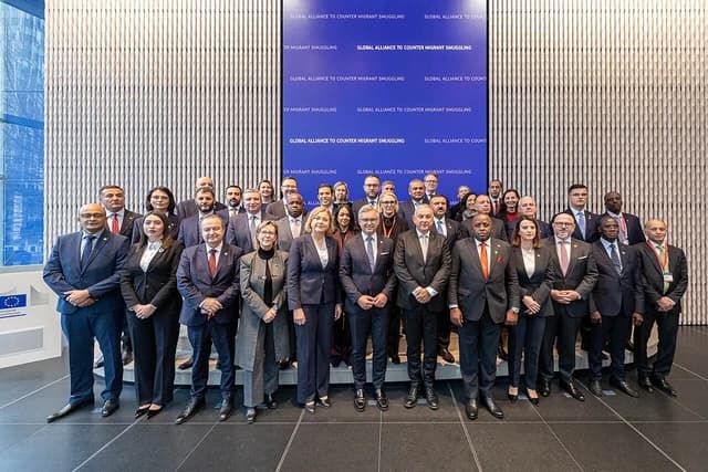 Magnus Bruner, EU migration commissioner, among a group of officials at an international conference.