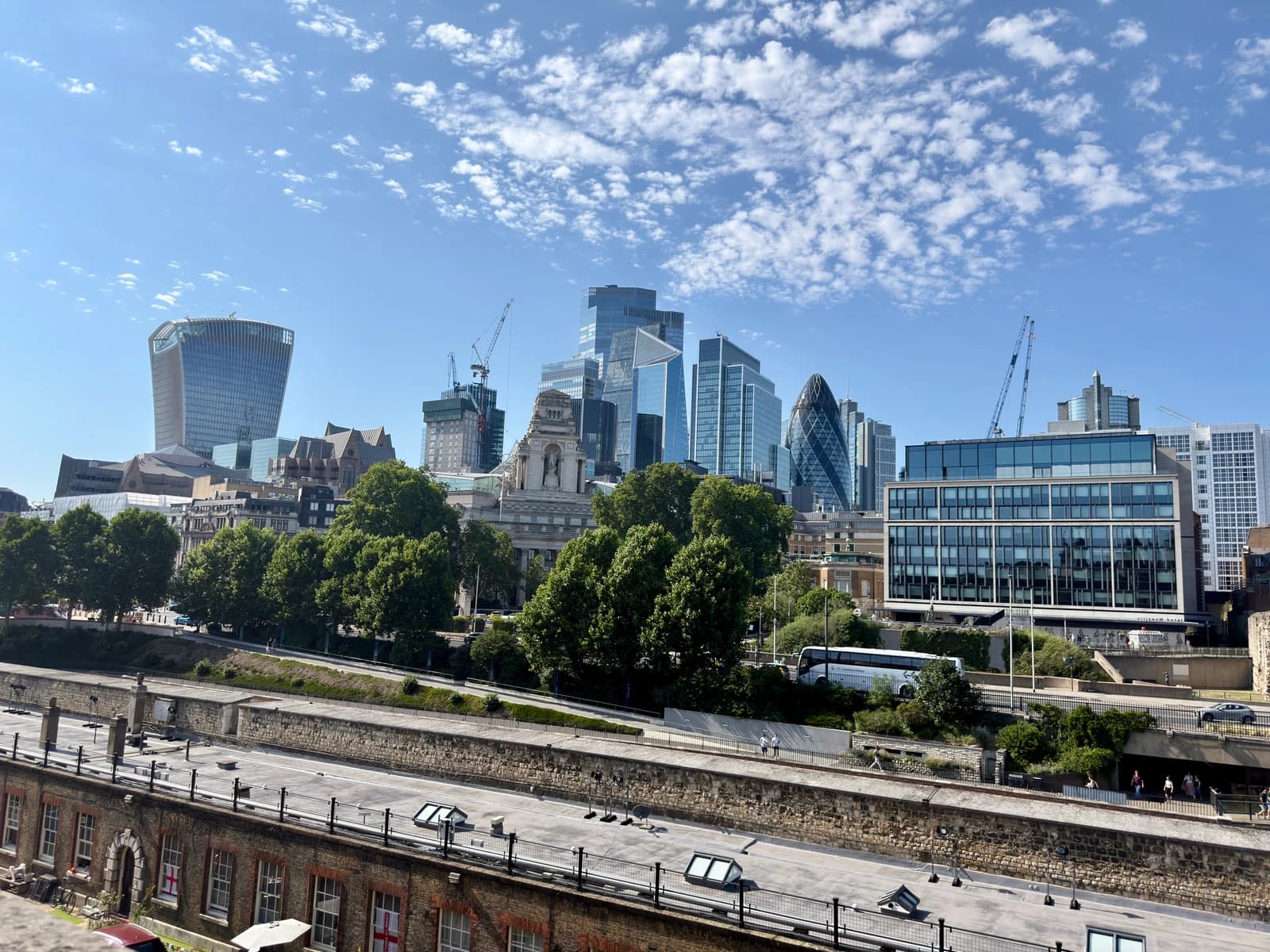 City of London financial district skyline with prominent modern skyscrapers under blue sky.
