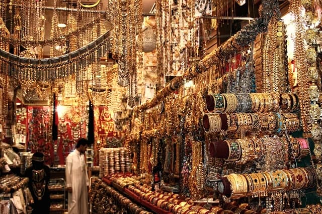 An elaborate display of gold and silver jewelry in a market stall.