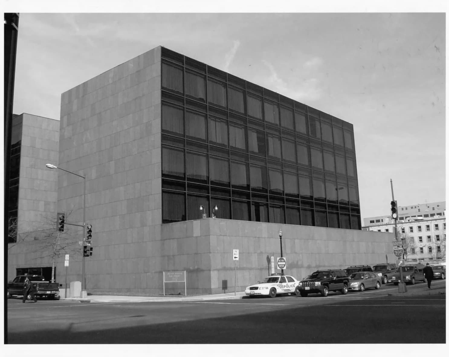 Exterior of the United States Tax Court Building, with cars and street furniture.