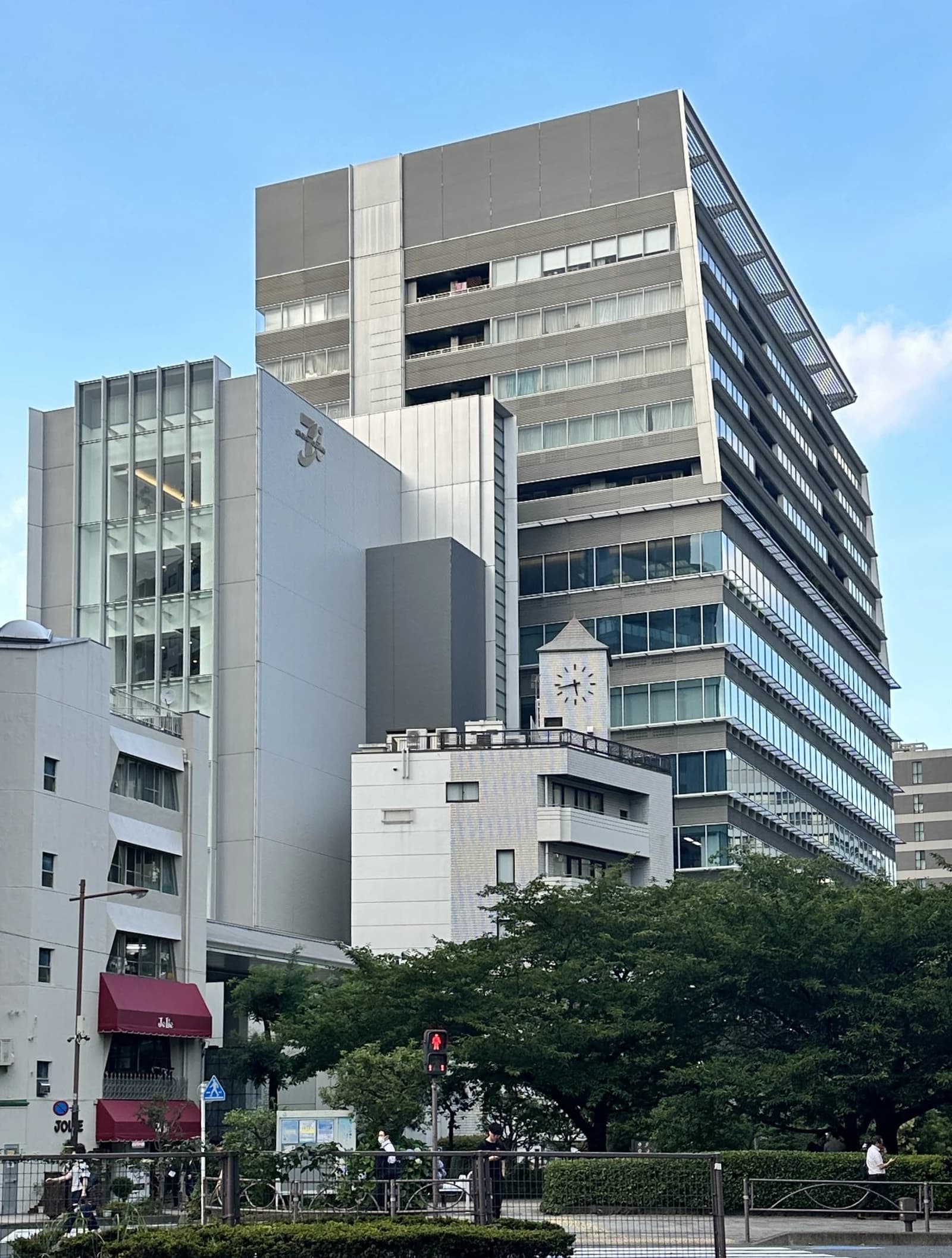 Exterior view of Seven & i Holdings headquarters building on a sunny day.