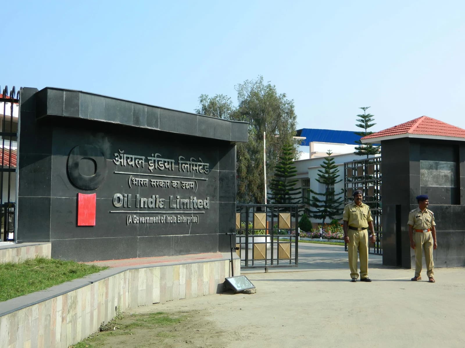 Entrance to Oil India Limited headquarters in Duliajan, Dibrugarh, with two security personnel.