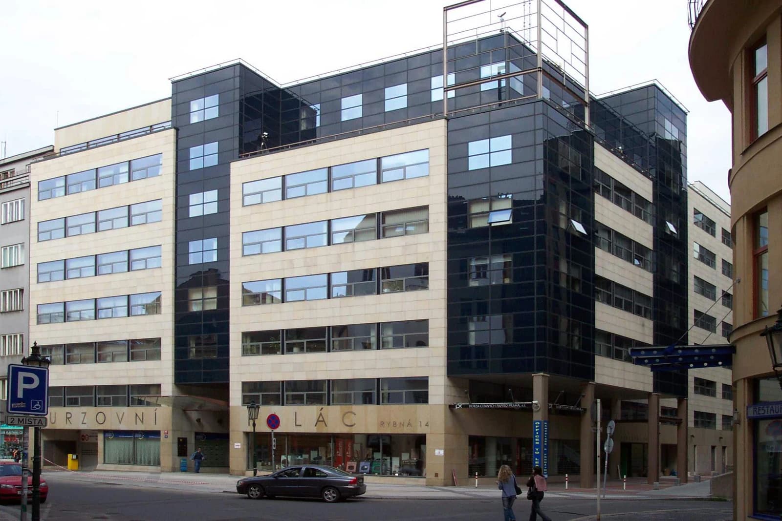 Modern office building with beige and dark glass facade in Prague, Czech Republic.