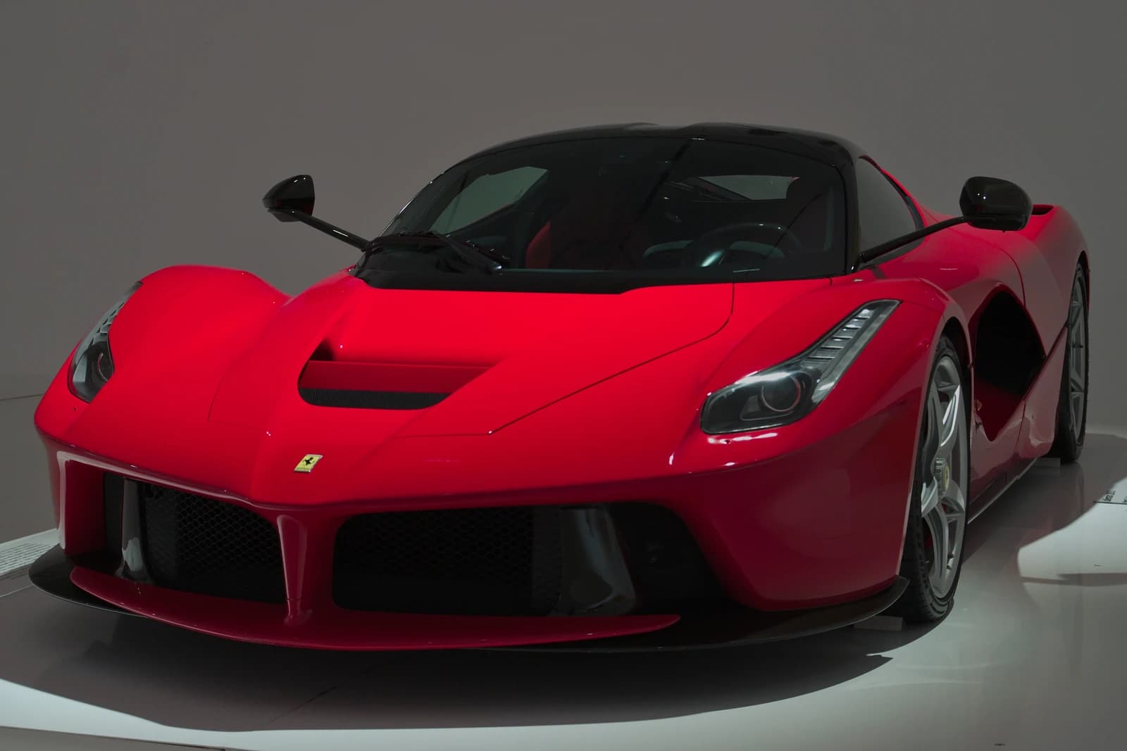 Red Ferrari LaFerrari sports car in a showroom at the Museo Enzo Ferrari.