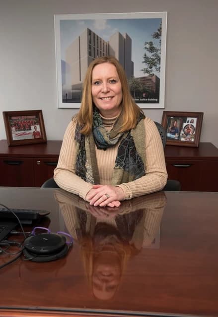 Jill Green, Member of Parliament for Fredericton, sitting at a desk in an office.