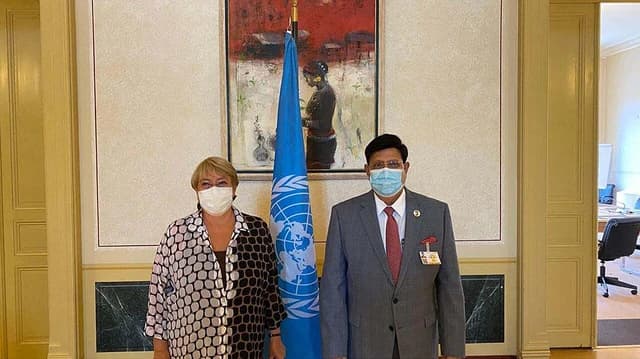 Michelle Bachelet, UN High Commissioner for Human Rights, stands with A. K. Abdul Momen in an office.