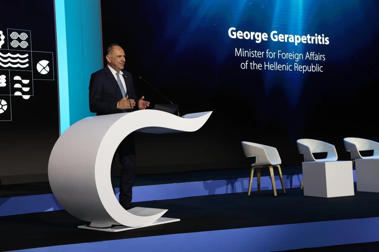 George Gerapetritis, Greek Minister for Foreign Affairs, speaking at a podium in Toronto.