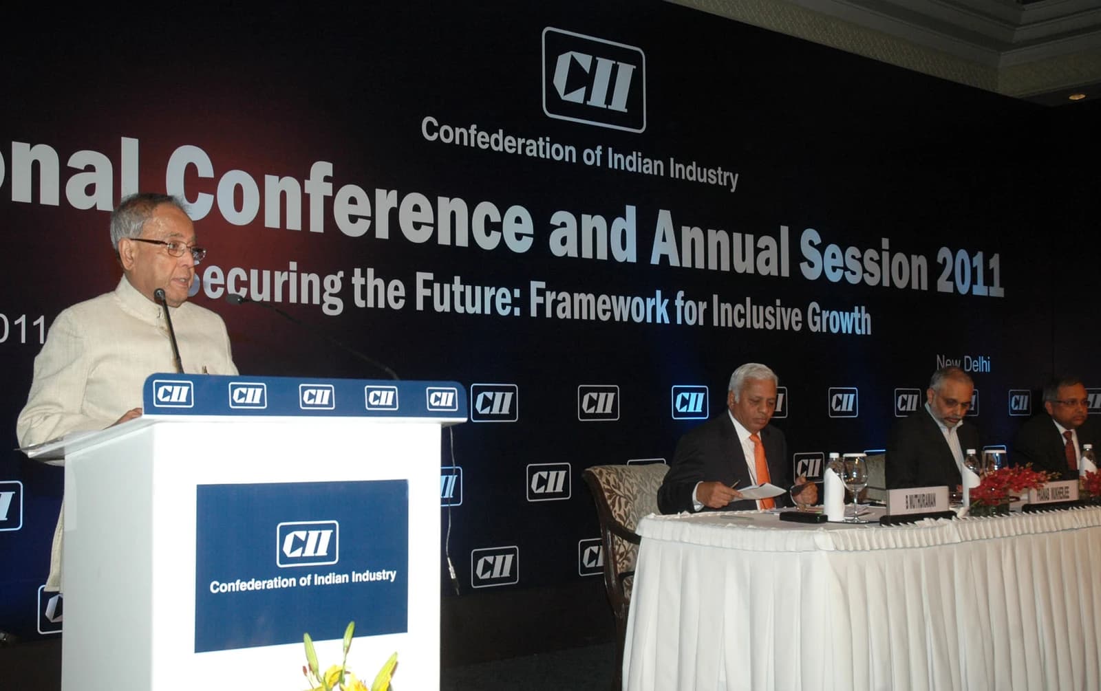 Pranab Mukherjee speaking at a podium during the Confederation of Indian Industry Annual Session.