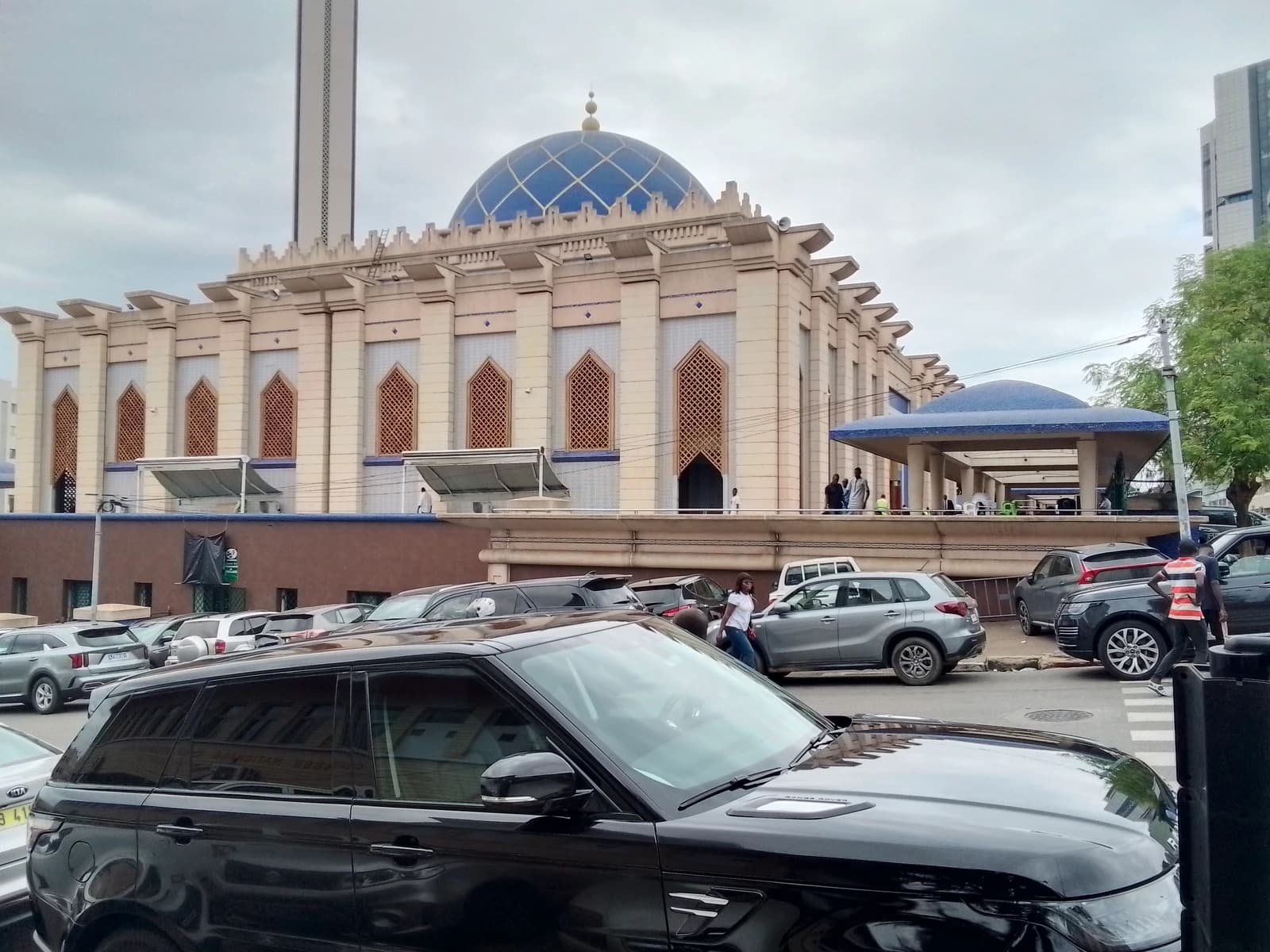 Grand Mosque of Abidjan in the Plateau district, Ivory Coast, with parked cars.