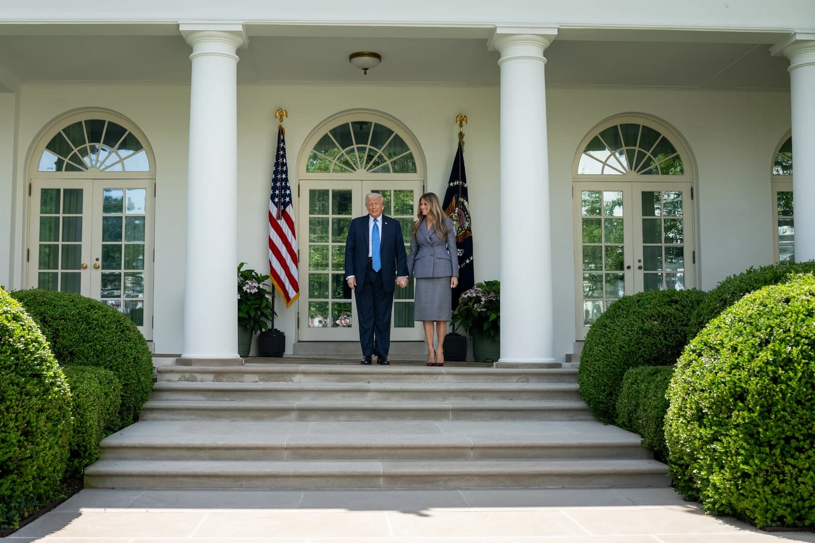 President Donald Trump and First Lady Melania Trump exit the White House Rose Garden.