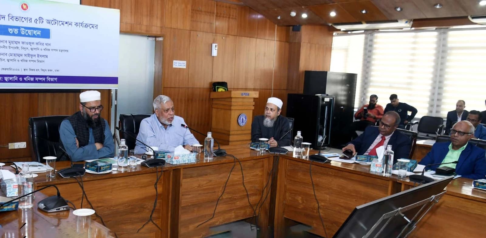 Muhammad Fouzul Kabir Khan, Advisor for Power, Energy, and Mineral Resources, speaking at a desk.