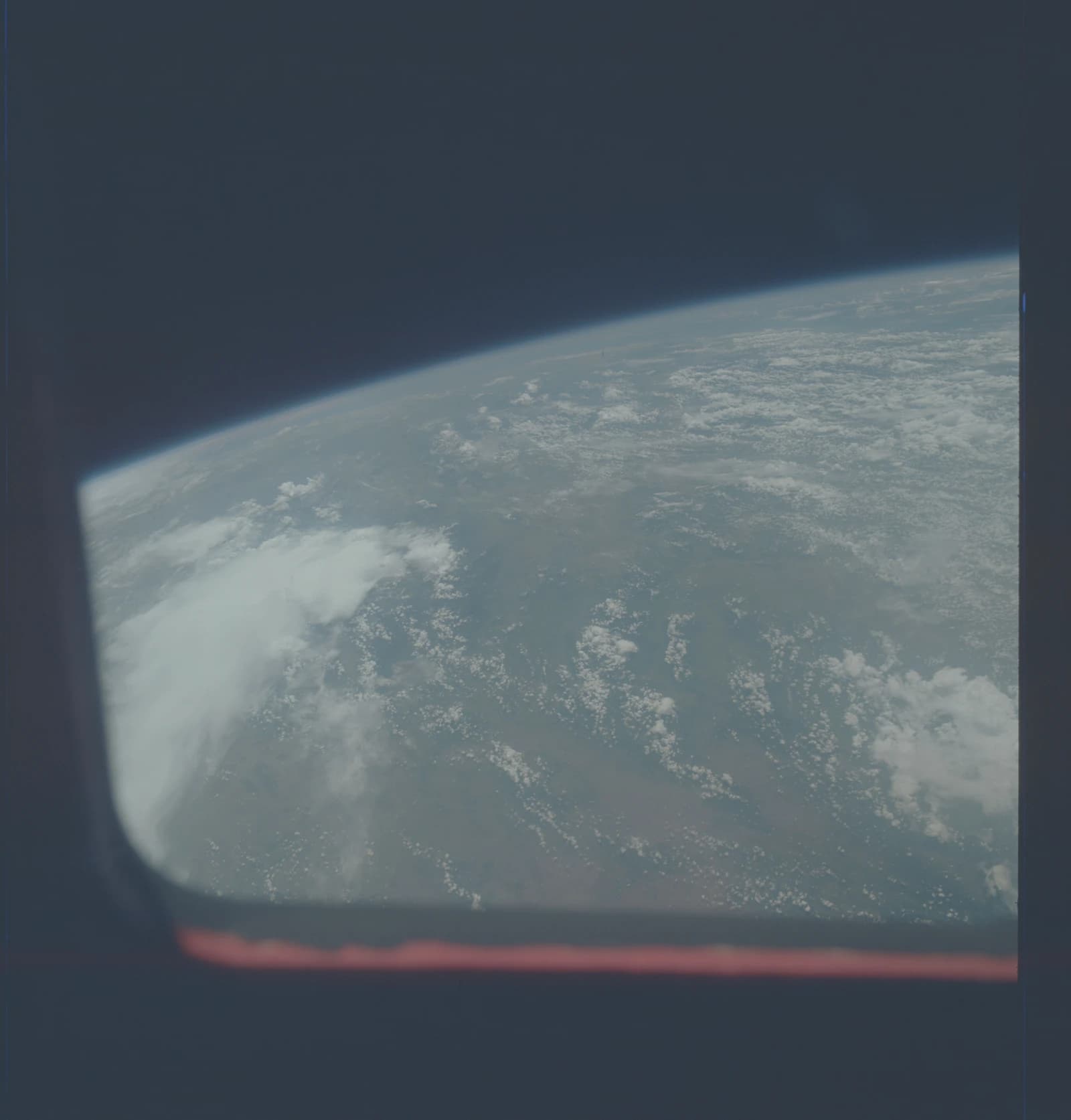 Earth as seen from orbit, showing cloud formations and land masses.