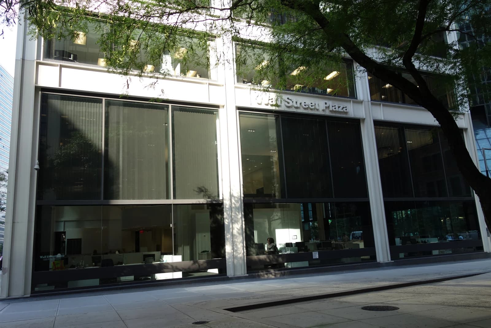 Exterior view of the Wall Street Plaza building with trees in the foreground.