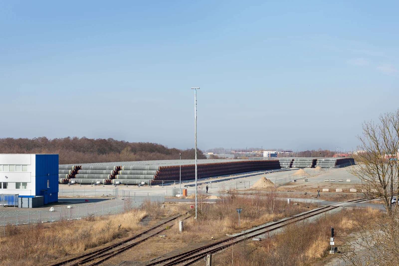 Nord Stream 2 pipes stored in a large open-air facility at Mukran Port.