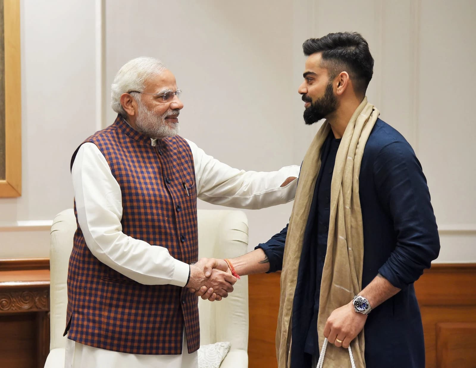 Indian Cricket Team Captain Virat Kohli shaking hands with Prime Minister Narendra Modi.