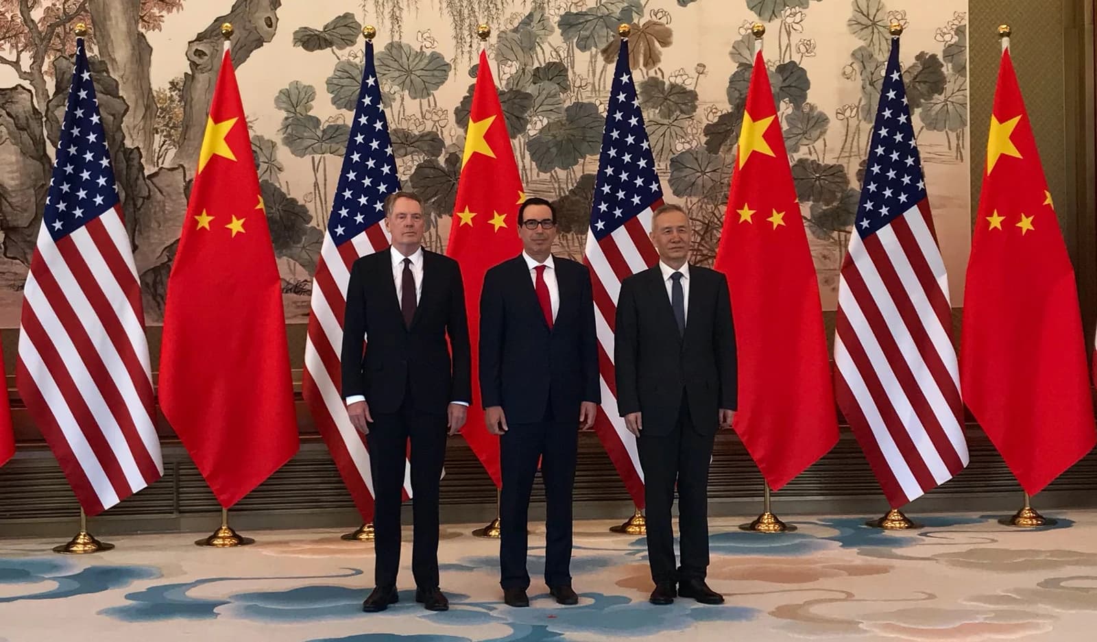 Robert Lighthizer, Steven Mnuchin, and Liu He stand together in a room.