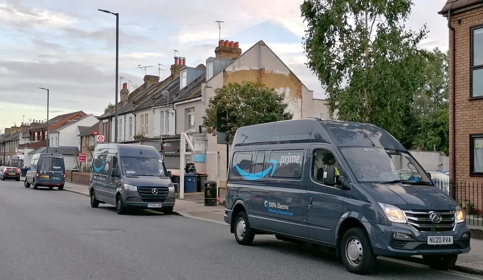 Multiple Amazon Prime electric delivery vans parked on a street in East Barnet.