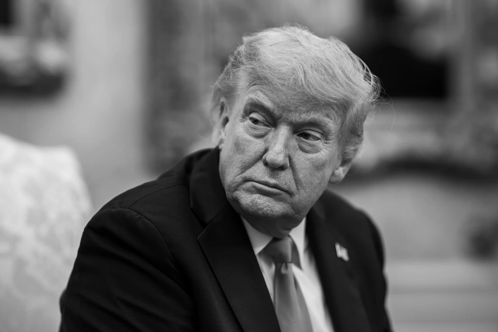 Donald Trump, former President of the United States, seated indoors.
